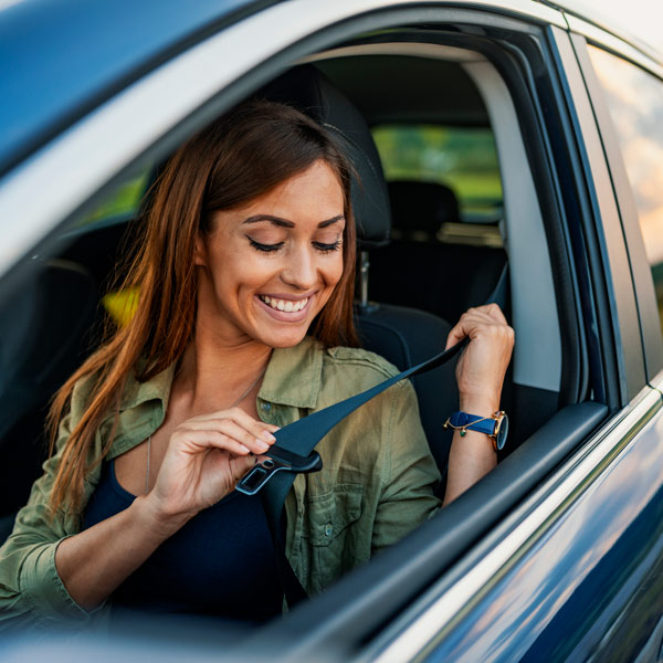 person buckling car seatbelt